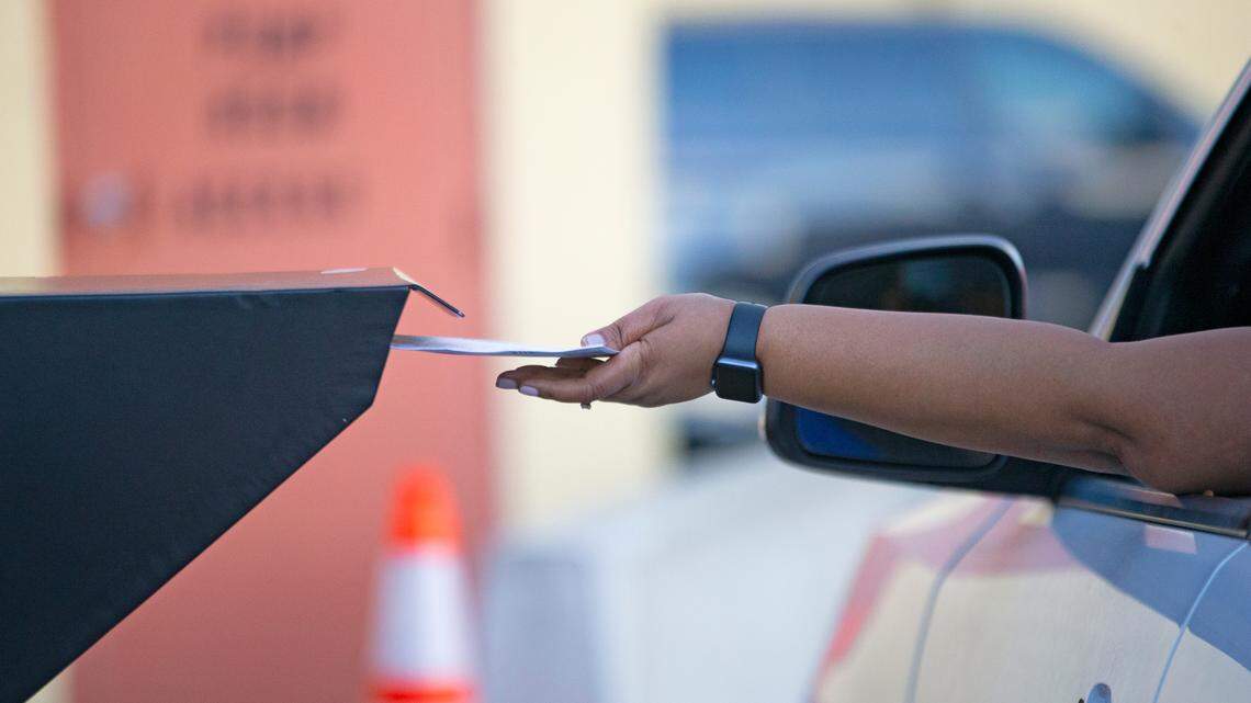 A Broward County resident deposits a ballot at the official drop box during the general election at the Lauderhill office of the Supervisor of Elections on Tuesday, Nov. 3, 2020, in Lauderhill.