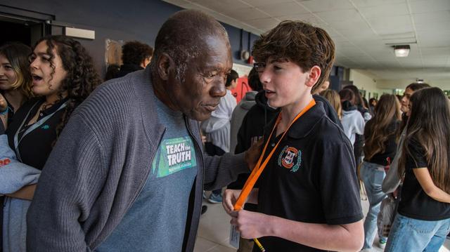 Palmetto Middle School student Jesse Messinger thanks Marvin Dunn, a renowned Black history author, emeritus professor at Florida International University and leader of the Center for Racial Justice, for his presentation about racism, discrimination and segregation to U.S. history students and civics students in Pinecrest, on Thursday, Feb. 1, 2024.