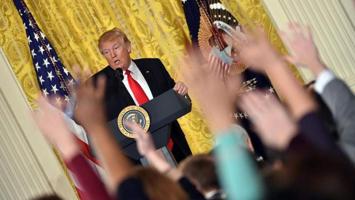 Reporters vie for President Trump’s attention during a press conference.