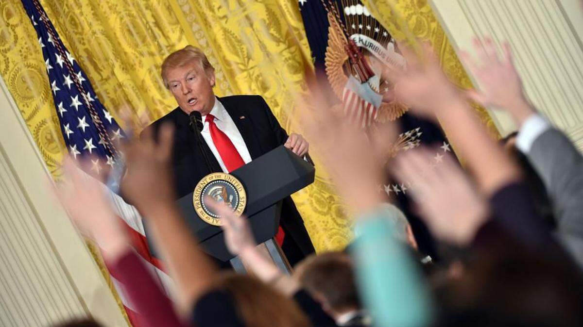 Reporters vie for President Trump’s attention during a press conference.