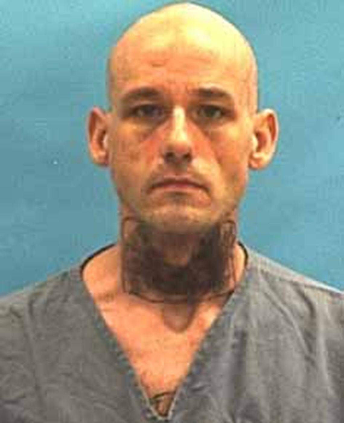 Michael Hart as he went to prison in March for methamphetamine possession. Inside the tattooed rectangle on his neck is the racial slur cover up of the gang patch.