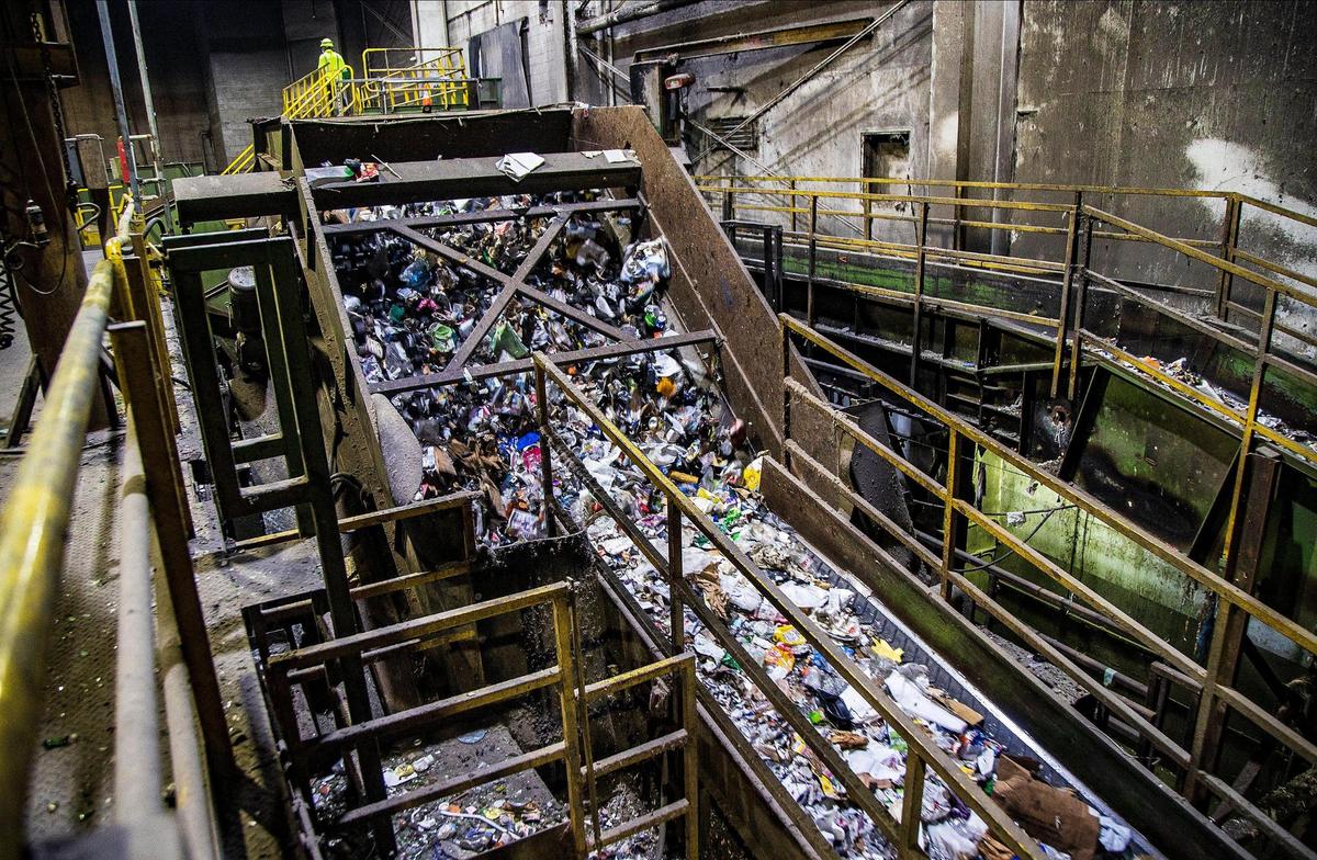 Recycled materials travel along a conveyor to be sorted at the Waste Management Recycling Plant in Pembroke Pines on April 8, 2022.