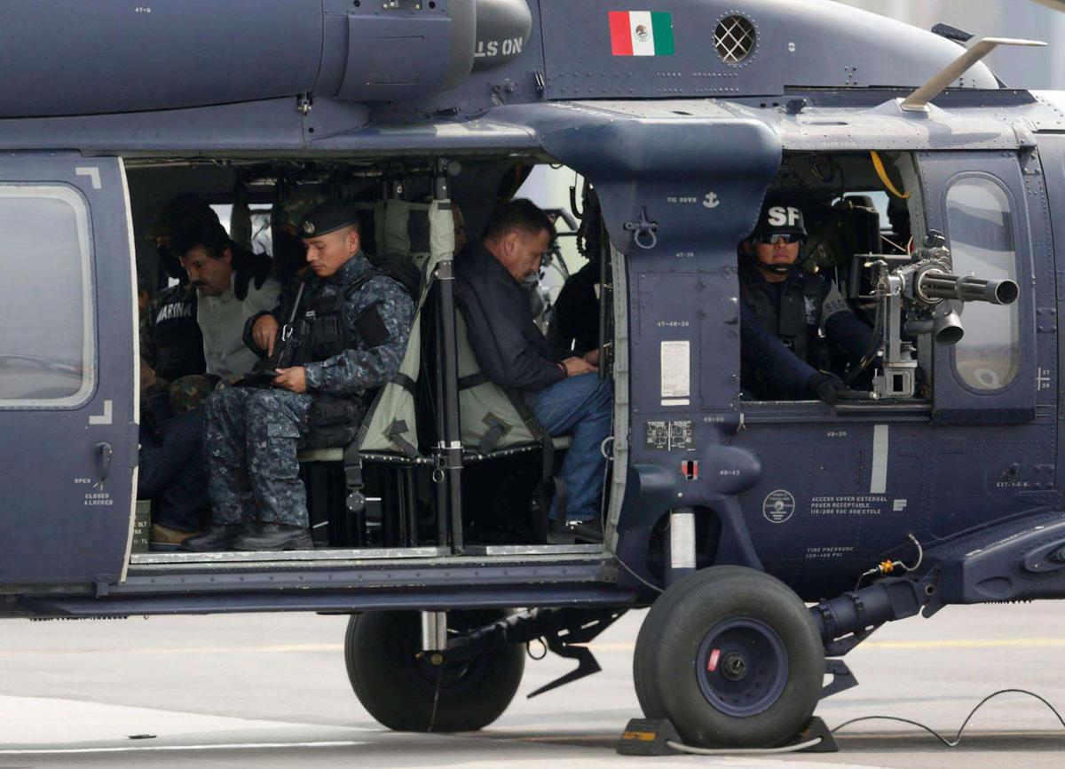 Joaquin ‘El Chapo’ Guzman, just captured, is seen sitting inside a Mexican federal police helicopter at the Navy’s airstrip in Mexico City Feb. 22, 2014.