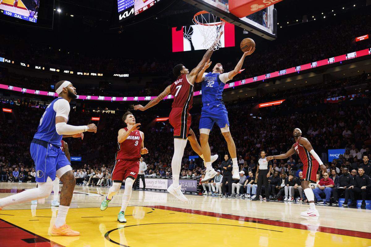 Miami Heat center Kel'el Ware (7) fouls Dallas Mavericks forward Cooper Flagg (32) during the second half of a game on Monday, Nov. 24, 2025, at the Kaseya Center in downtown Miami, Fla. The Miami Heat won 106-102.