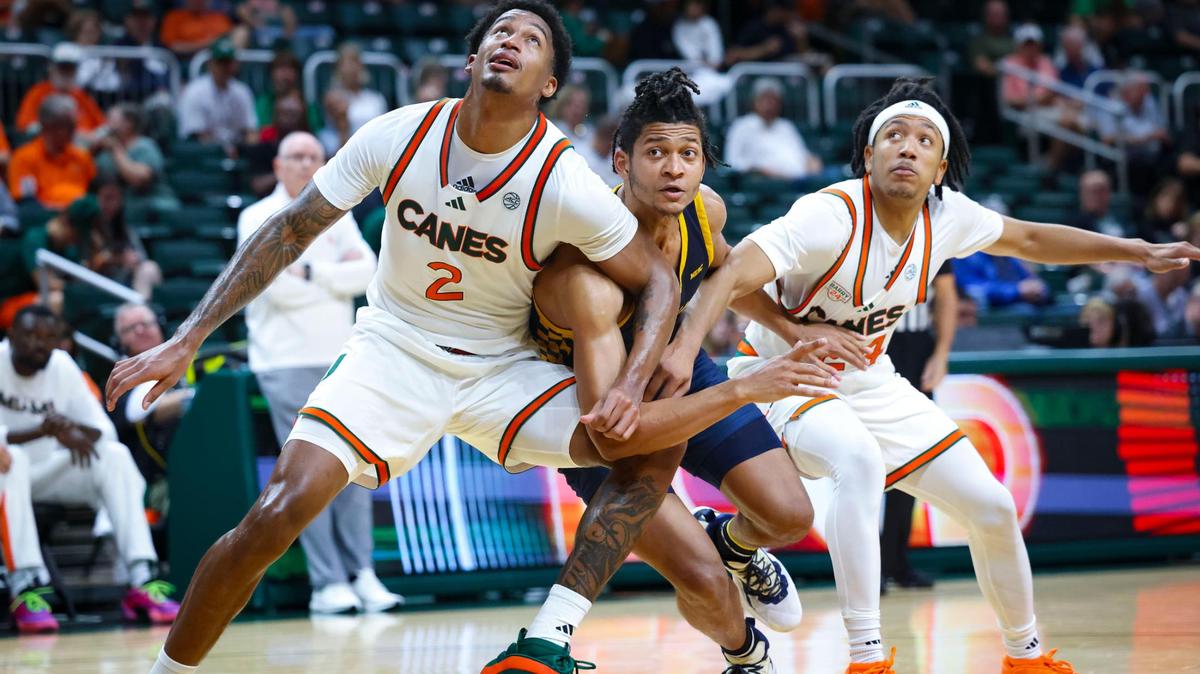 Miami Hurricanes forward Brandon Johnson (2) and Miami Hurricanes guard Nijel Pack (24) box out Coppin State Eagles forward Peter Oduro (12) during the first half of a game on Sunday, Nov. 17, 2024, at the Watsco Center in Coral Gables, Fla.