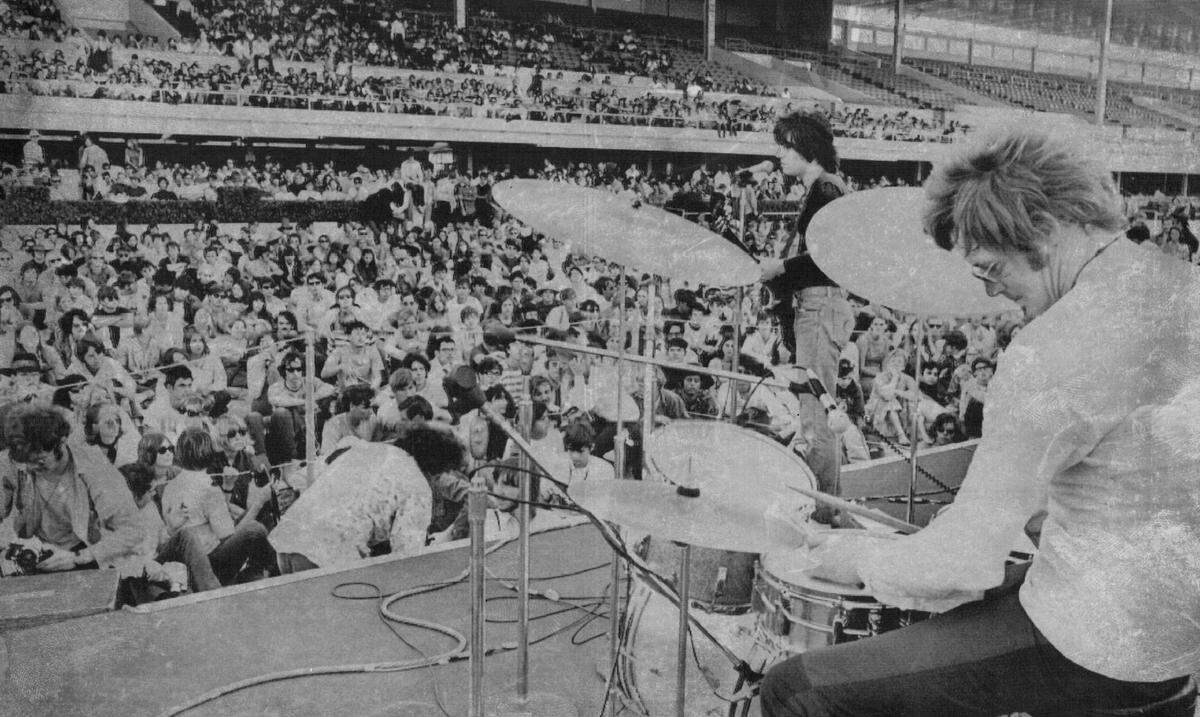 In 1968, long-haired teenagers mingle with hippies as they listen to bands at a pop music festival in Gulfstream Park in Hallandale Beach.