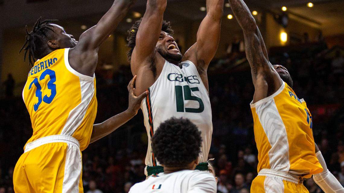 Hurricanes forward Norchad Omier (15) fights for a rebound with Panthers players Jamarius Burton (11) and Federiko Federiko (33) during an NCAA basketball game at Watsco Center in Coral Gables, Florida, on Saturday, March 4, 2023.