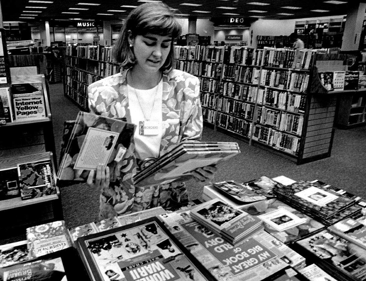 Shari Valcourt, general manager of the new Aventura Borders Books and Music store, sets up a book display in 1995. The bookstore is long gone and the building is now occupied by other businesses.