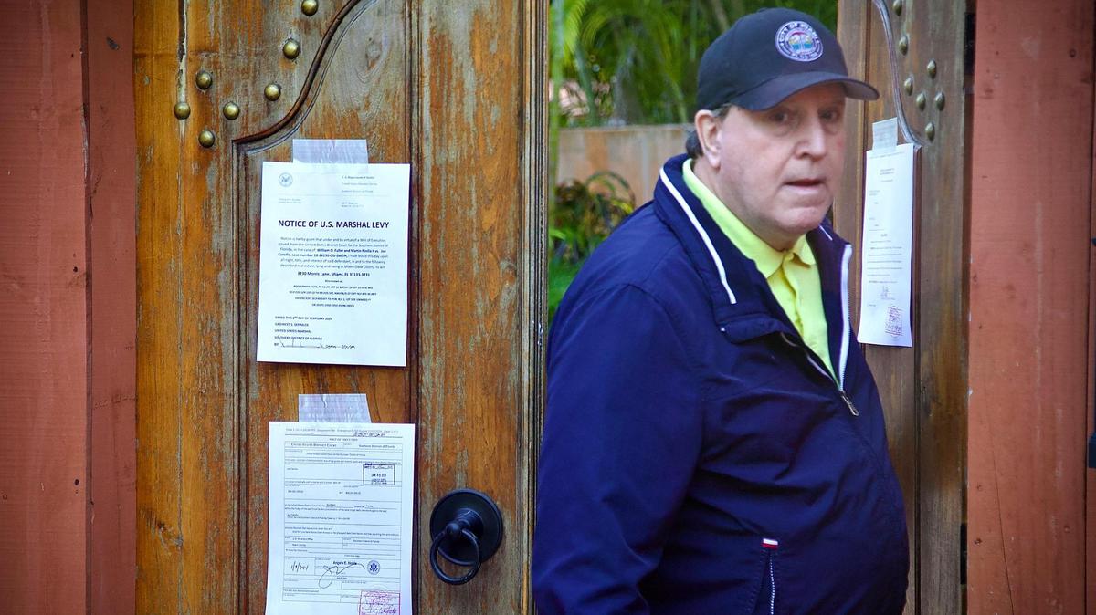 Joe Carollo comes out of his house to talk to reporters in front of his residence in Coconut Grove on Friday, Feb. 2, 2024. U.S. Marshals have begun the process to seize the property after he lost a civil trial accusing him of misusing his public office.
