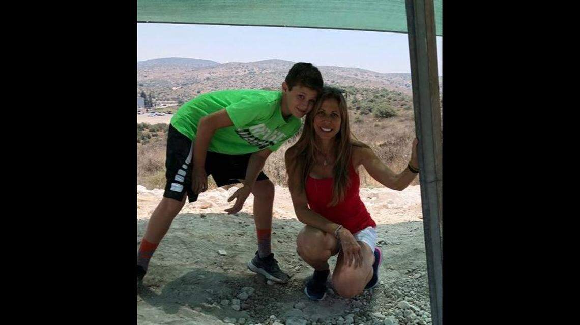 Stacie Fang with her son, 15-year-old Jonah Handler. Both were pulled alive from the rubble of the Surfside condo collapse. Stacie Fang later died, but Jonah has survived.