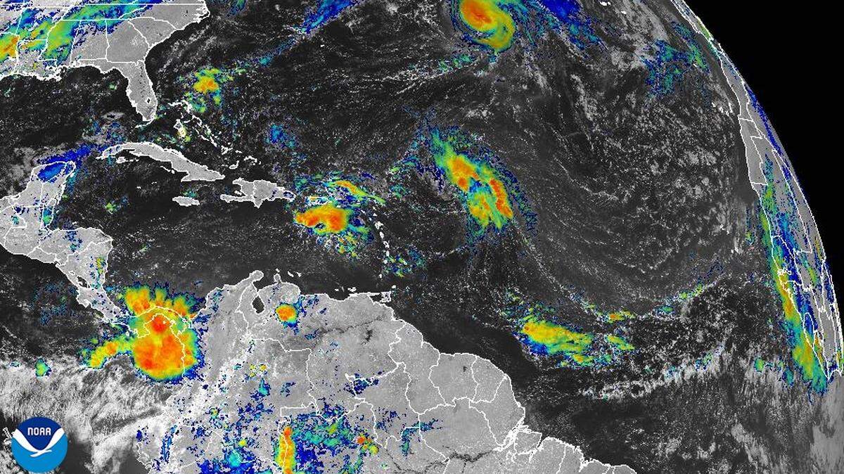This satellite image, taken on Wednesday, shows two tropical waves that could develop along parallel tracks -- or potentially combine -- in the Atlantic.