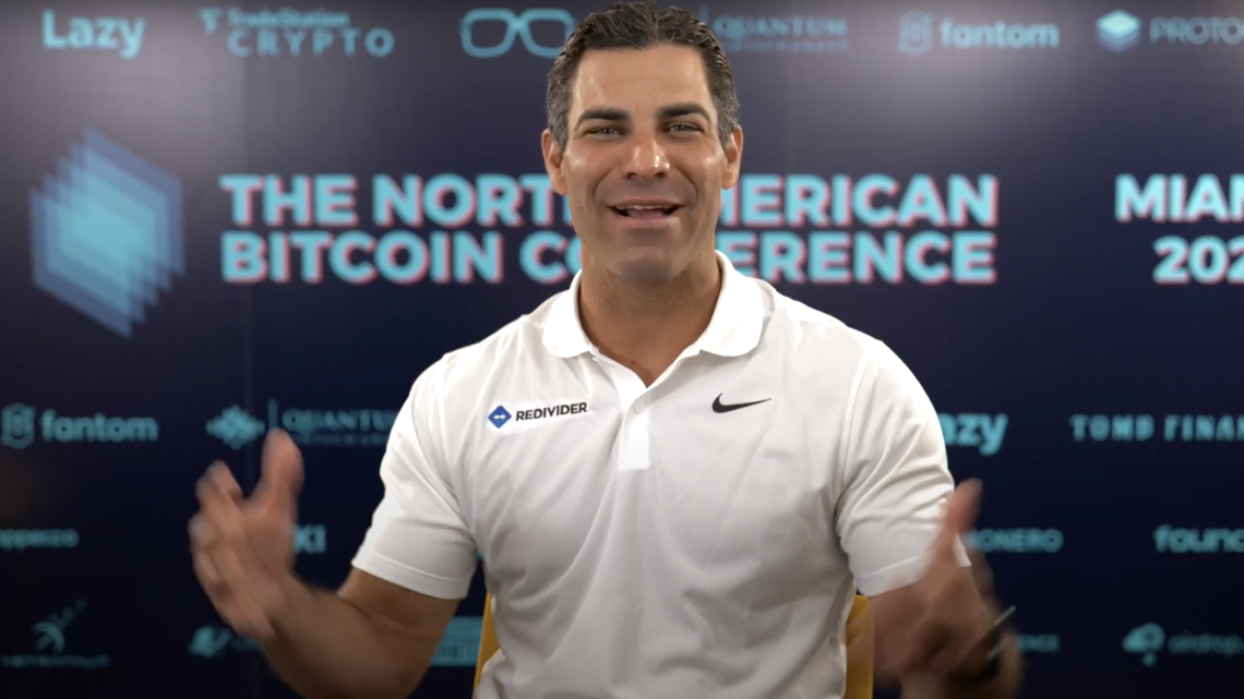 Miami Mayor Francis Suarez wears a shirt featuring the logo of one of his private employers, Redivider, as he addressed the North American Bitcoin conference in 2022.