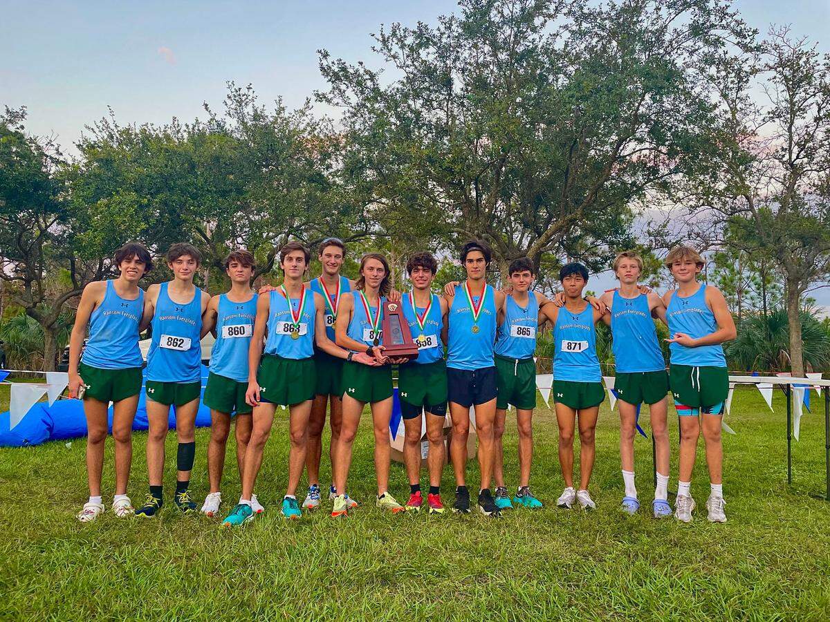 Ransom Everglades’ boys’ cross-country team celebrates its Region 4-2A championship on Friday at South County Regional Park in Boca Raton, Fla.
