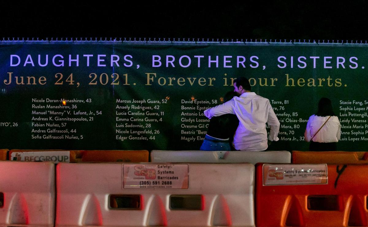 People near the site of the former Champlain Towers South condo building on Friday, June 24, 2022 in Surfside, Fla. Family members of the 98 victims of the June 24, 2021 condo collapse gathered at the site to mark the one year anniversary of the tragedy.