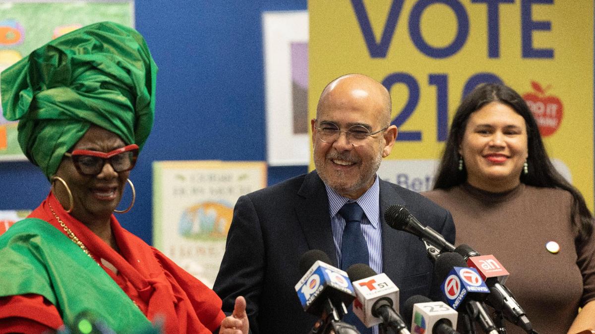 Jose Dotres, superintendent of Miami-Dade County Public Schools, center, speaks with School Board members Dorothy Bendross-Mindingall, left, and Lucia Baez-Geller, during a press conference, Thursday, Oct. 6, 2022, at Madie Ives K-8 Center in Miami to promote the Nov. 8 referendum. The district is asking voters to boost their property taxes to fund teacher raises and school resource officers.