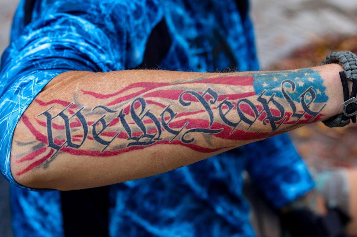 A demonstrator shows his ‘We the People’ tattoo outside the Wilkie D. Ferguson Jr. U.S. Courthouse, Tuesday, June 13, 2023, in Miami, where former President Donald Trump will be arraigned Tuesday afternoon. Trump is facing 37 charges related to his handling of classified documents after he left the White House.
