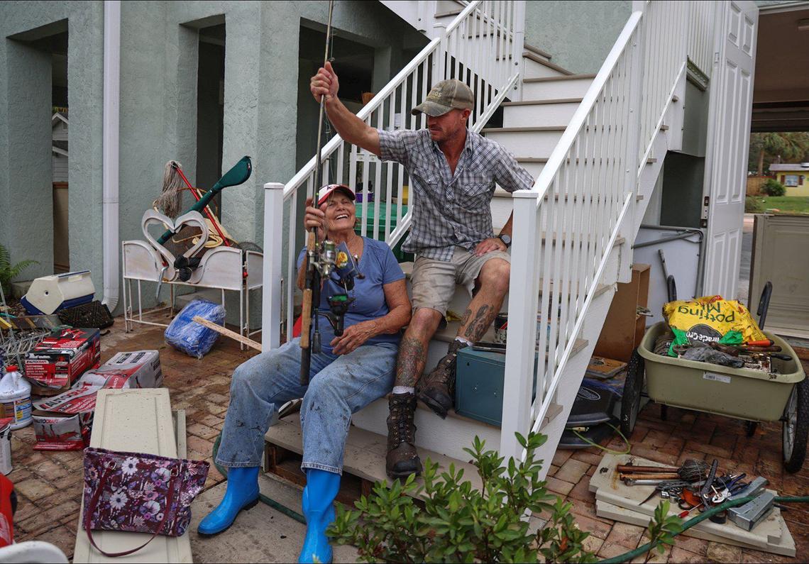 Hurricane Milton’s storm surge moved and damaged boats, cars, and devastated homes not built up to code. With the help of her grandson, James Kirby, 38, right, Marilyn Gladish, 83, salvaged many items from the ground floor of her home. The pair take a break from cleaning and sorting her belongings on Friday, October 11, 2024, in Port Charlotte, Florida.