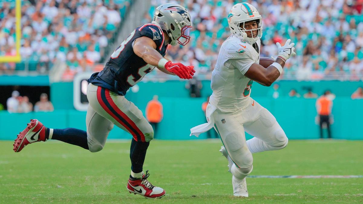 Miami Dolphins tight end Jonnu Smith (9) on a pass reception as New England Patriots linebacker Christian Elliss (53) defends in the first half during their NFL football game at Hard Rock Stadium in Miami Gardens, Florida, on Sunday, November 24, 2024.
