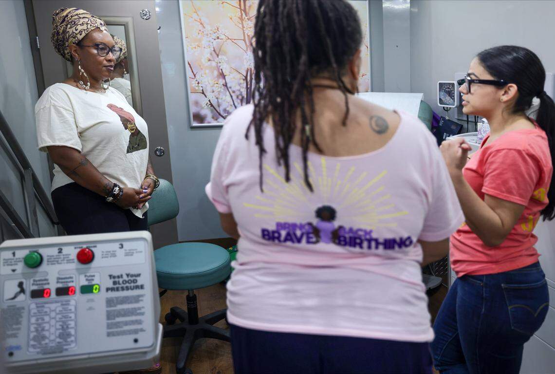 Jamarah Amani, executive director of the Southern Birth Justice Network, left, Sheila Simms Watson, head midwife at SBJN, and Melanie Asevey, right, engage with their first patient inside the Mobile Midwife Clinic at the Overtown Youth Center in Miami, Florida, on Thursday, April 16, 2026.
