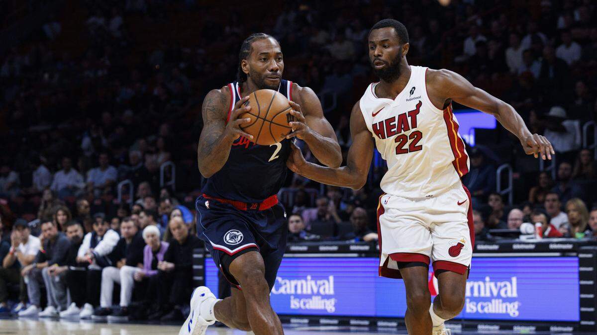 Los Angeles Clippers forward Kawhi Leonard (2) drives around Miami Heat forward Andrew Wiggins (22) during the first quarter of a game on Dec. 1, 2025, at Kaseya Center in Miami.