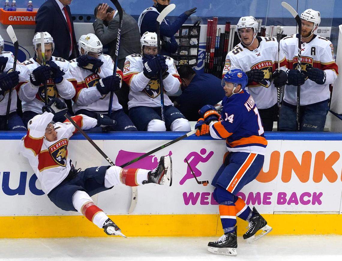 TORONTO, ONTARIO - AUGUST 01: Frank Vatrano #77 of the Florida Panthers falls to the ice after colliding with Tom Kuhnhackl #14 of the New York Islanders during the third period in Game One of the Eastern Conference Qualification Round prior to the 2020 NHL Stanley Cup Playoffs at Scotiabank Arena on August 1, 2020 in Toronto, Ontario, Canada. (Photo by Andre Ringuette/Freestyle Photo/Getty Images)
