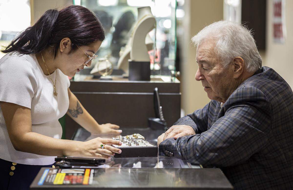 Eddie Snow helps Cindy Xie shop for a wedding band at Snow's Jewelers on Friday, Jan. 9, 2025, in Coral Gables, Fla. The jewelry shop, which has operated for more than 50 years, is closing its Miracle Mile location as owners Eddie and Judy prepare to retire in April.