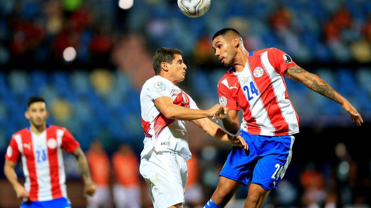 GOIANIA, BRAZIL - JULY 02: Aldo Corzo of Peru head the ball against Hector David Martinez of Paraguay ,during the Quarterfinal match between Peru and Paraguay as part of Conmebol Copa America Brazil 2021 at Estadio Olimpico on July 2, 2021 in Goiania, Brazil. (MB Media/Sipa USA)