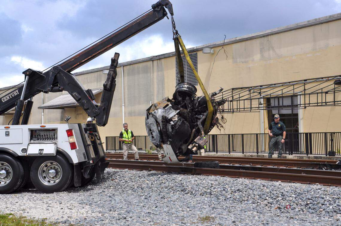 A crane removes a crushed Maserati from the railroad tracks in Oakland Park after Clivet Romero, 46, was killed in a fiery Brightline crash in September 2019. Romero saw a slow-moving freight train and drove around the gates to try to beat it. A police report said Romero was ‘oblivious’ to the fact that a much faster Brightline train was approaching from the other direction.
