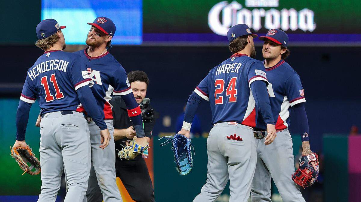 United States shortstop Gunnar Henderson (11), and United States first baseman Bryce Harper (24) both chest bump teammates United States shortstop Bobby Witt Jr. (7), second from the left, and United States second baseman Brice Turang (13) after beating the Dominican Republic to advance to the finals at the end of semi-finals of the World Baseball Classic United States vs. Dominican Republic at the loanDepot Park on Sunday, March 15, 2026, in Miami, Florida.
