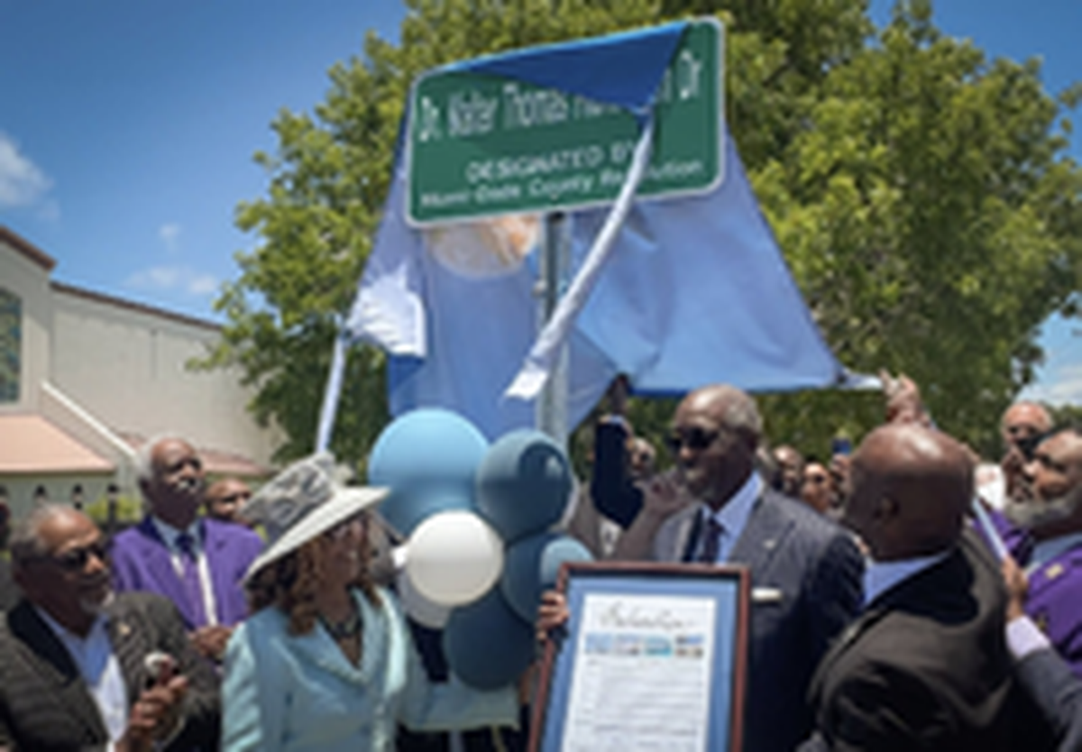M. Dolores Richardson, center-left, and husband Dr. Walter Thomas Richardson, center-right, stand underneath the sign that bears his name during the street naming ceremony. On Sunday, June 4, 2023 Miami-Dade Commissioner Kionne L. McGhee hosted a street naming ceremony to honor community leader Dr. Walter Thomas Richardson at Sweet Home Missionary Baptist Church, 10701 SW 184th St., Miami.