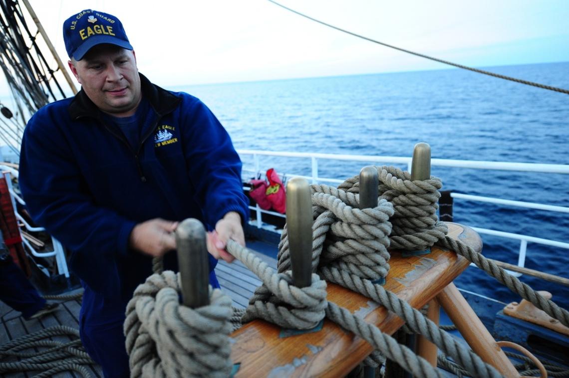 U.S. Coast Guard Barque Eagle crewman Petty Officer 1st Class John Presnar handles a line while adjusting sails aboard the Eagle Sept. 17, 2012. Presnar shot and killed his wife and two children, before turning the gun on himself in December 2018.