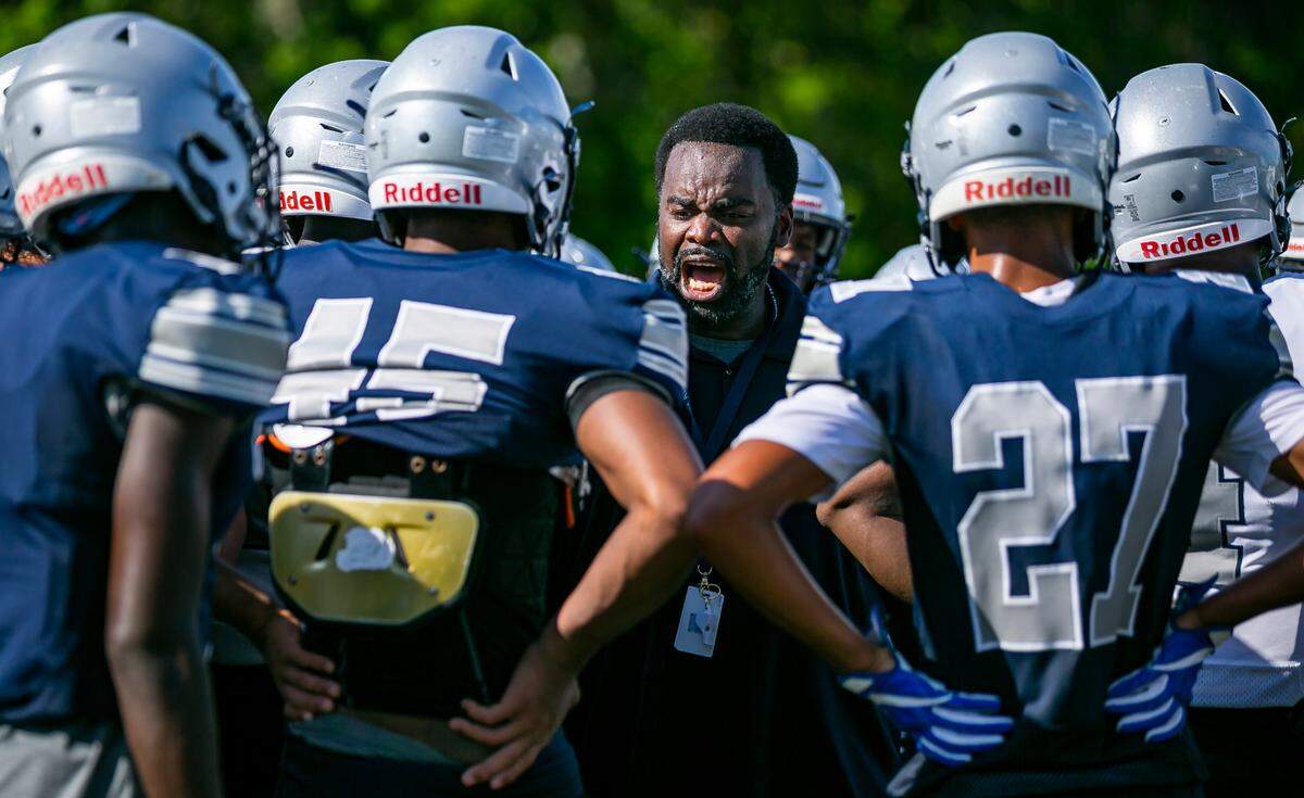 Gulliver Prep football coach Earl Sims runs drills with his team during a preseason practice at their field in Pinecrest, Florida on Monday, August 9, 2021.