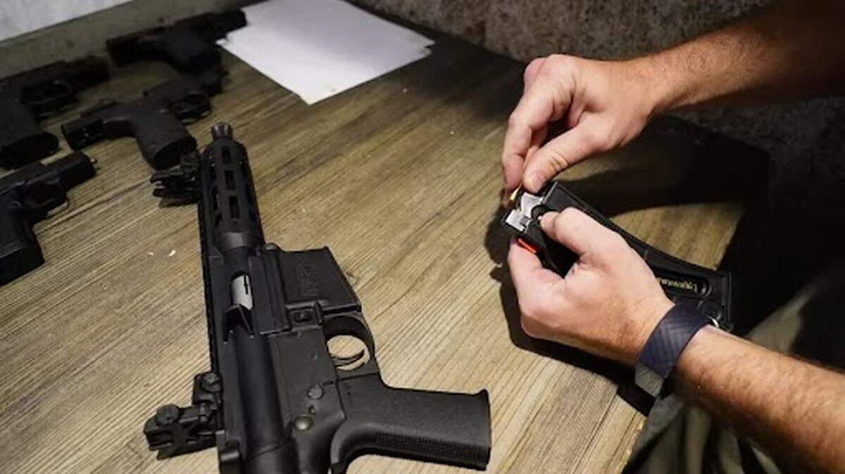 Smith & Wesson regional sales manager Will Sloat, 33, loads a pistol on Saturday, April 30, 2022, at Bill Jackson’s in Pinellas Park. 