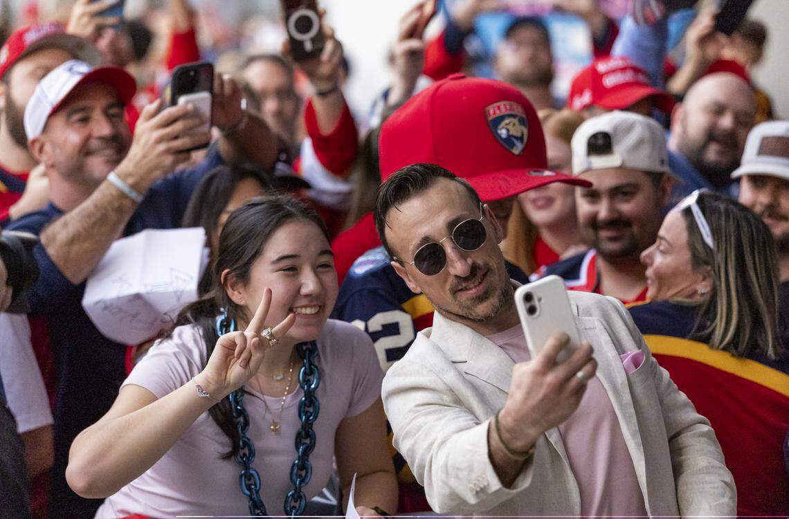 Florida Panthers left wing Brad Marchand (63) takes a selfie with a fan as he arrives to loanDepot for his Winter Classic outdoor hockey game against the New York Rangers on Friday, Jan. 2, 2026, in Miami, Fla.