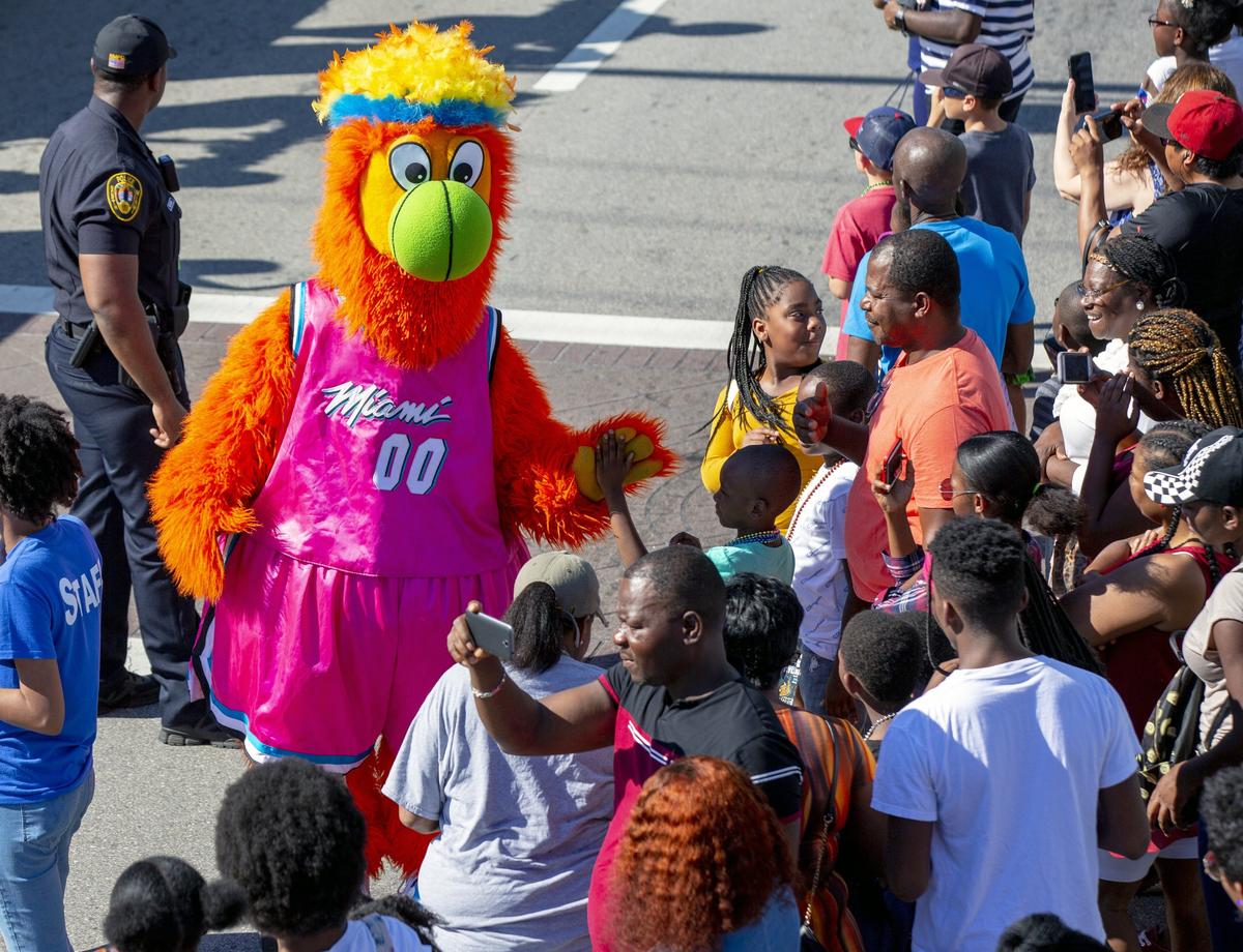 The Miami Heat mascot, Burnie, greets parade goers during the 45th Annual Winternational Thanksgiving Day Parade in front of North Miami City Hall in North Miami, Florida on Thursday, November 28, 2019.