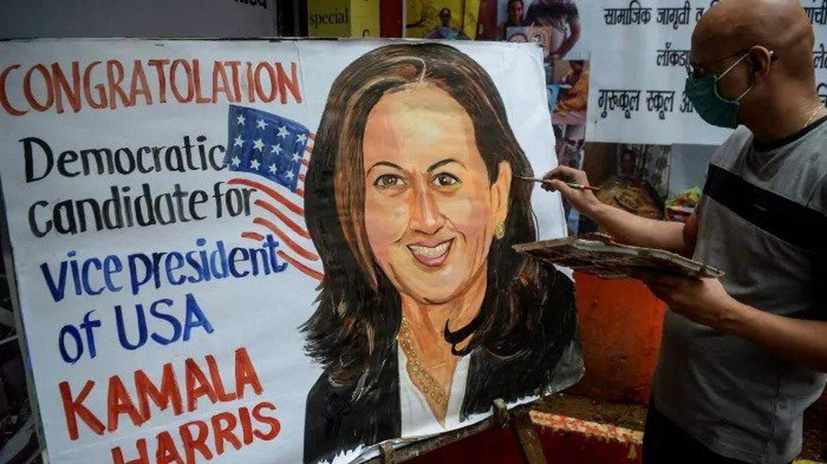 An artist paints a billboard in Mumbai celebrating Kamala Harris being named the Democratic vice-presidential nominee.