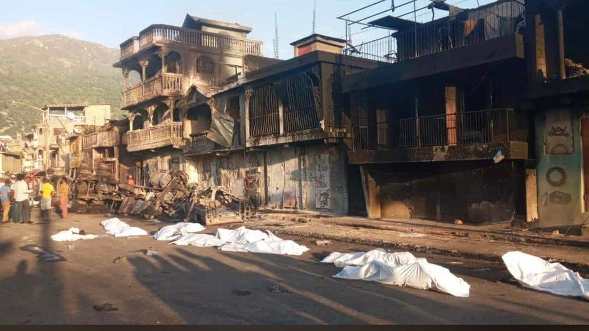 The remains of some of those killed in the gasoline explosion in Cap-Haitien lie on the street.