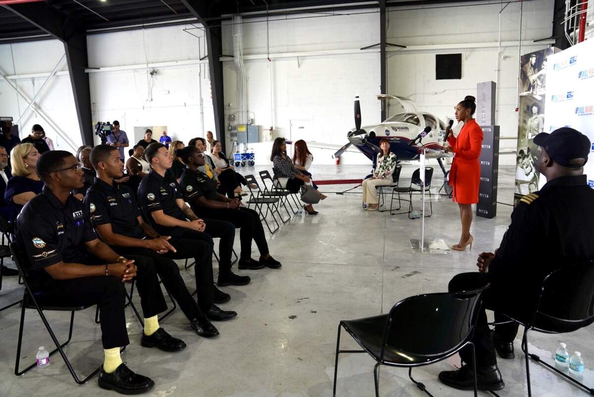 United Way Miami President and CEO Symeria Hudson speaks to UpSkill Miami alumni at Opa-locka Executive Airport.