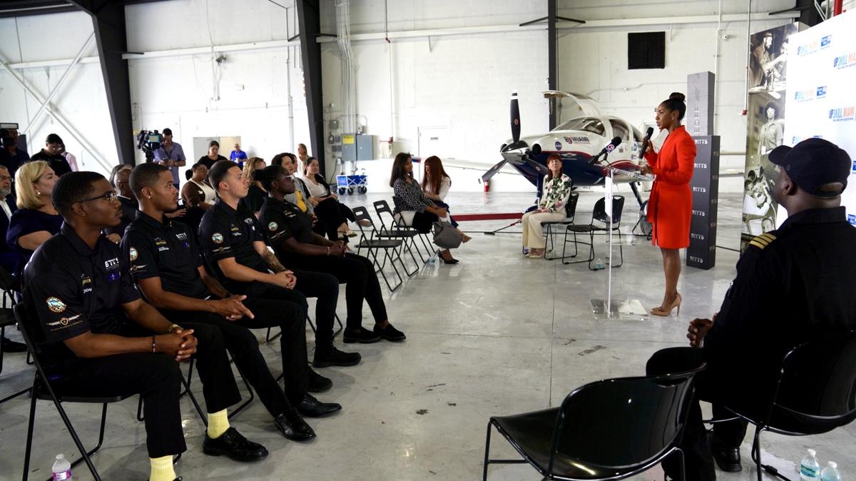United Way Miami President and CEO Symeria Hudson speaks to UpSkill Miami alumni at Opa-locka Executive Airport.