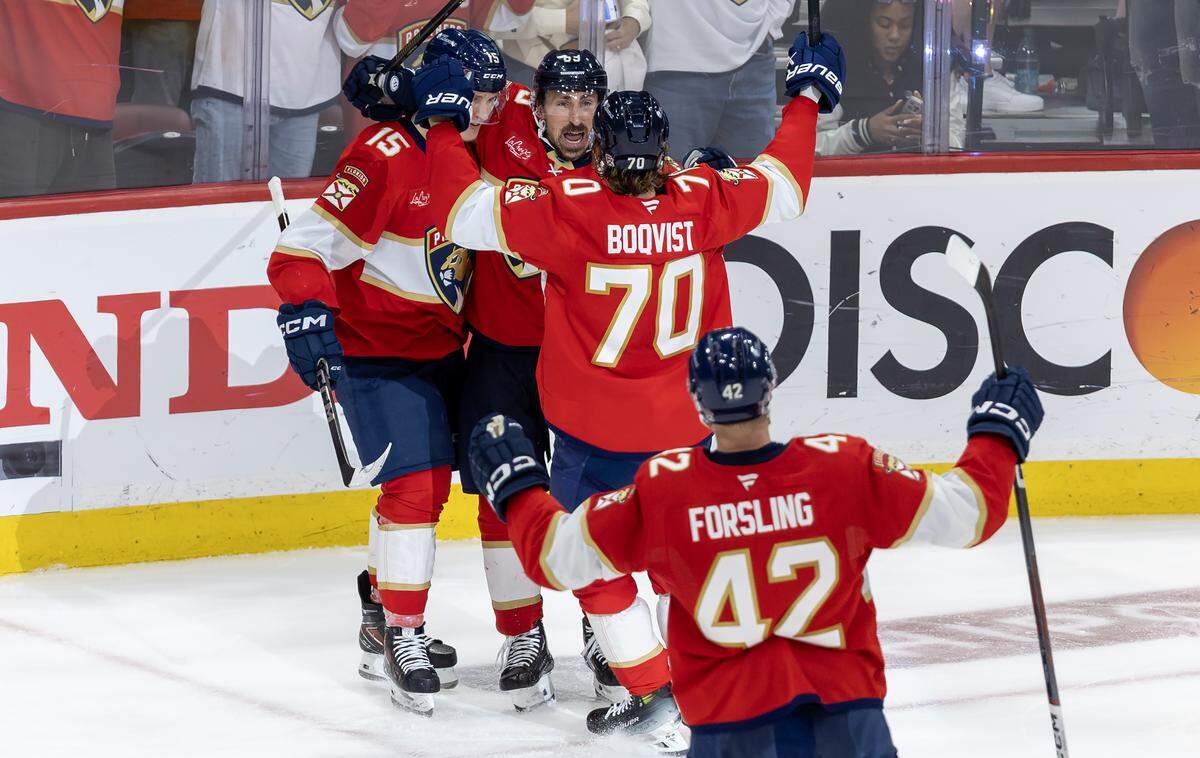 Florida Panthers center Brad Marchand (63) celebrates with teammate Anton Lundell (15) Jesper Boqvist (70) and Gustav Forsling (42) after scoring against the Carolina in the third period of Game 3 in the Eastern Conference Final of the NHL Stanley Cup Playoffs at Amerant Bank Arena on Saturday, May 24, 2025, in Sunrise, Fla.