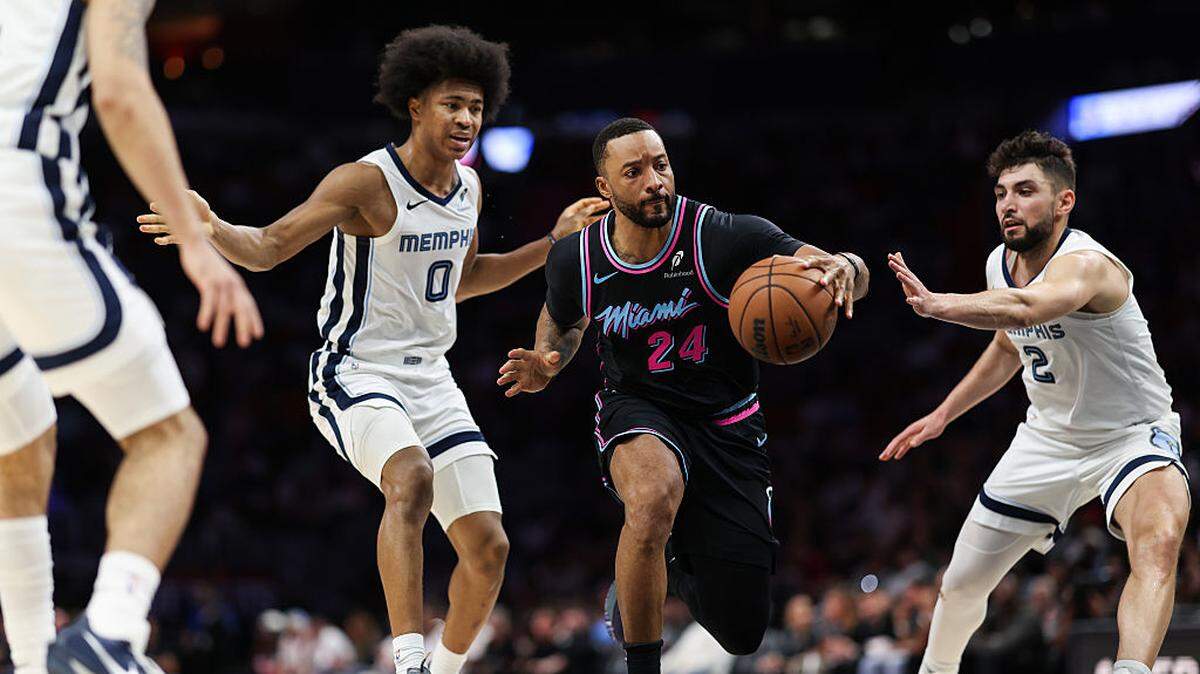 Norman Powell #24 of the Miami Heat drives the ball past Jaylen Wells #0 of the Memphis Grizzlies during the fourth quarter of the game at Kaseya Center on February 21, 2026 in Miami.