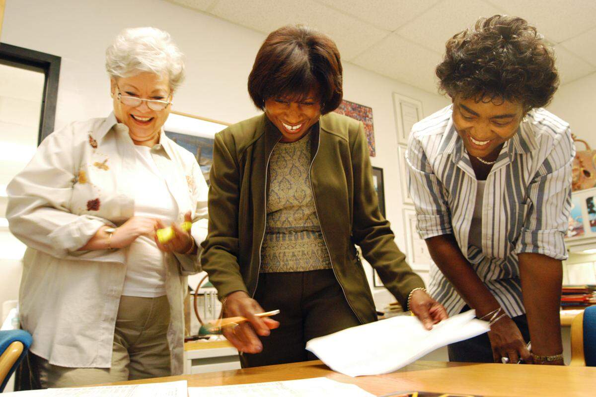 New World School of the Arts Principal Ellery Brown (center), and two other school employees look over FCAT scores in 2004.