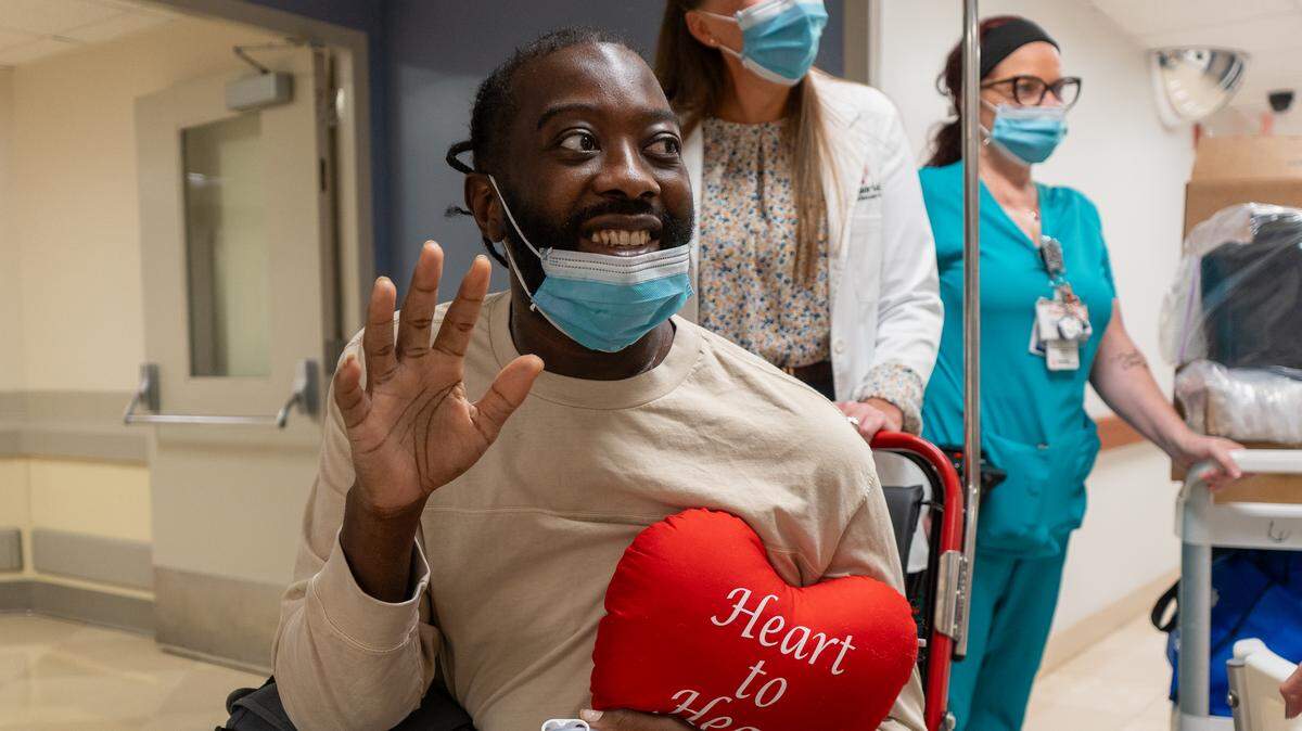 Chevon Byfield, 39, waves goodbye to medical staff as he is wheeled out of Memorial Regional Hospital in Hollywood, Florida, on Monday, March 30, 2026, with his new heart. It took nearly seven years for him to find a heart match.