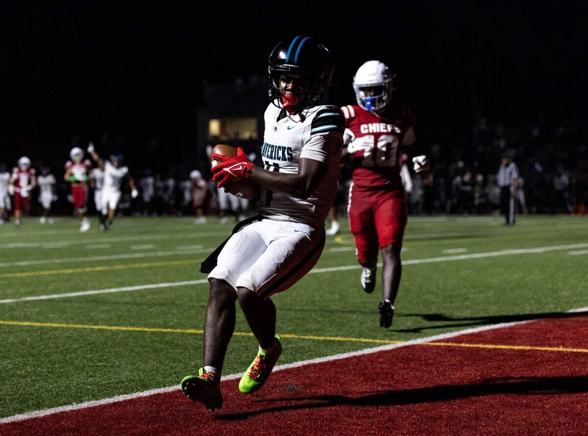 Archbishop McCarthy receiver Malik Denson (4) scores a touchdown as Chiefs cornerback Preston Stebbins (10) looks on during a football game at Cardinal Gibbons High School on Thursday, August 21, 2025, in Miami, Fla.