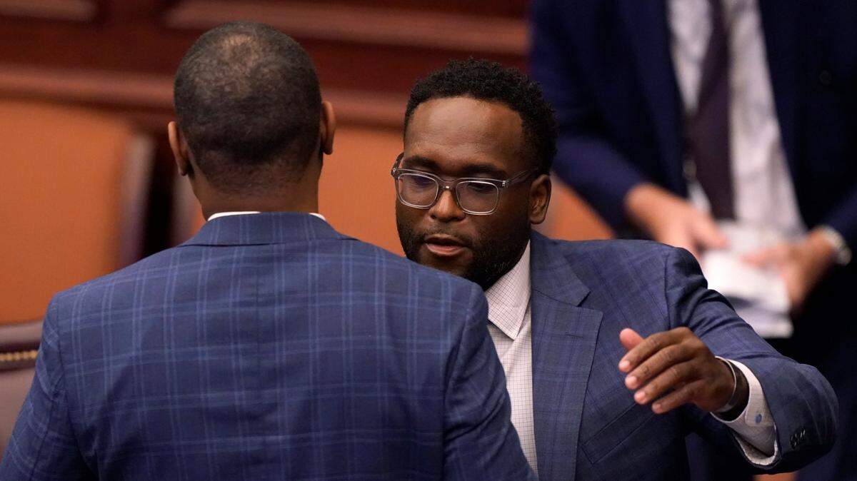 State Sen. Shevrin D. Jones, right, hugs Randolph Bracy after speaking about a law enforcement bill during a legislative session, Thursday, April 29, 2021, at the Capitol in Tallahassee, Fla.