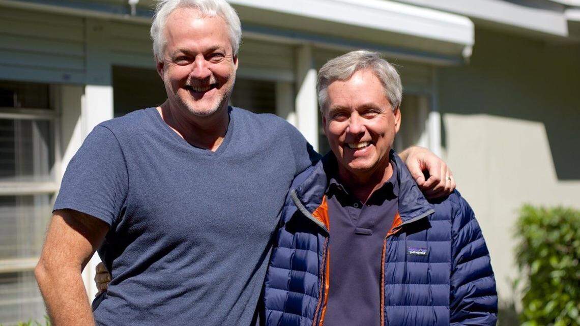 Carl Hiaasen, right, stands with his brother, Rob, outside of their mother’s home in Plantation, where they both grew up.