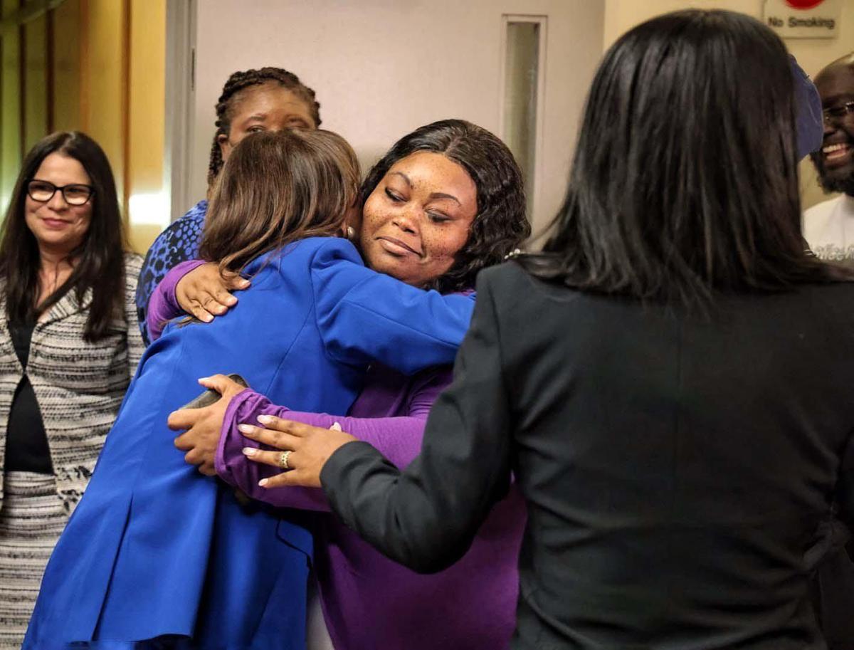 Katherine Fernandez Rundle, left, embraces Thomas James’ cousin, Santay Thompson, center, as his family members react after his murder conviction was vacated by Judge Miguel M. de la O in courtroom 4-3 on Wednesday, April 27, 2022.