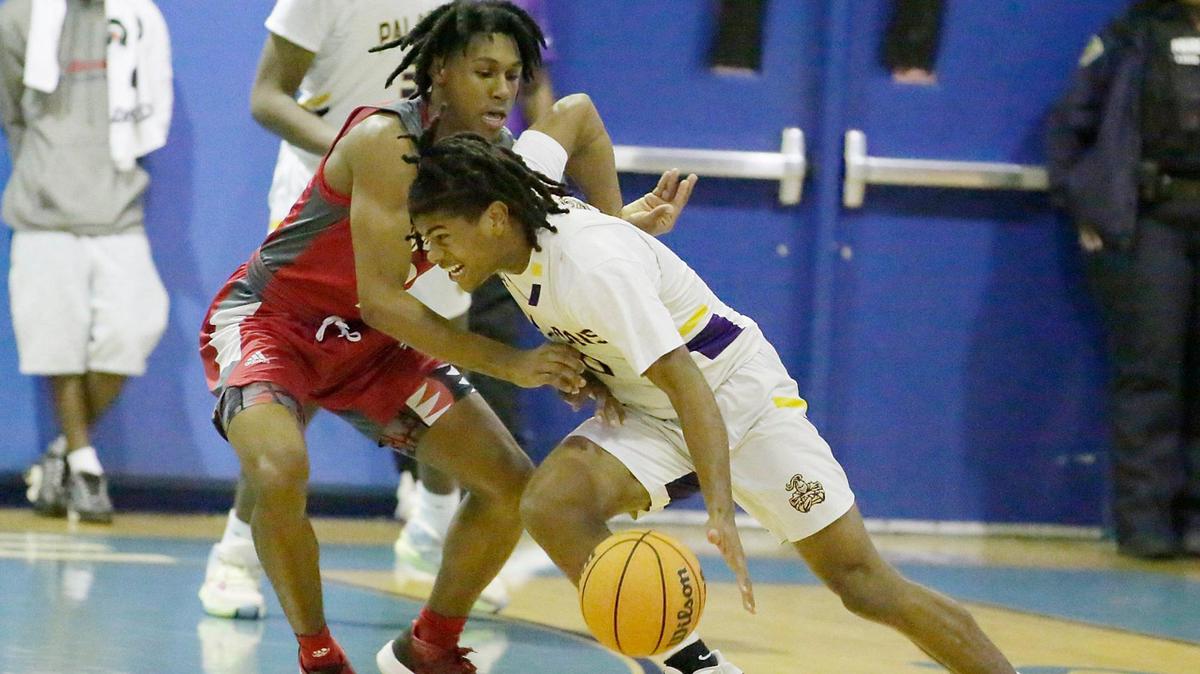South Plantation Paladins Kaiden Francis controls the ball during the BCAA Boys Big 8 2023 Basketball championship game against Cardinal Gibbons Chiefs on Saturday at Fort Lauderdale High School.