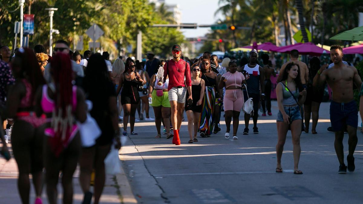 South Beach visitors make their way down Ocean Drive in Miami Beach, Florida during the start of Memorial Day Weekend on Friday, May 28, 2021.