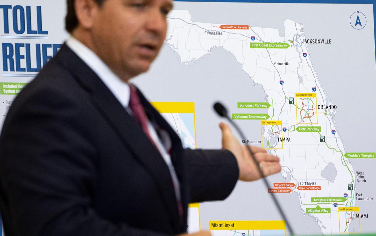 Florida Governor Ron DeSantis points to highways included in a toll relief program for people who travel over 35 times per month on toll roads during press conference on Monday, April 1, 2024, at the Greater Miami Expressway Agency in Miami.